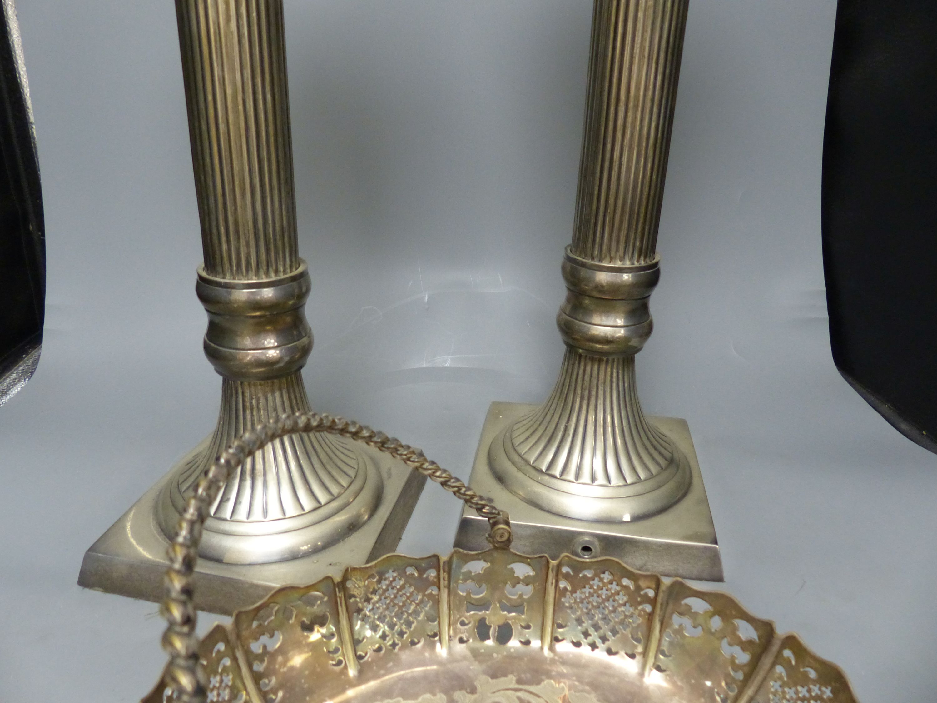 A pair of large plated electric table lamps, each square base marked AWEP, and a plated cake basket